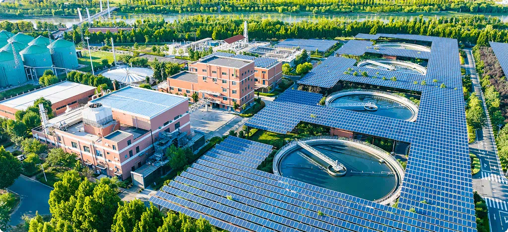 Overhead perspective of a solar power plant in China, featuring extensive arrays of solar panels and surrounding landscape.
