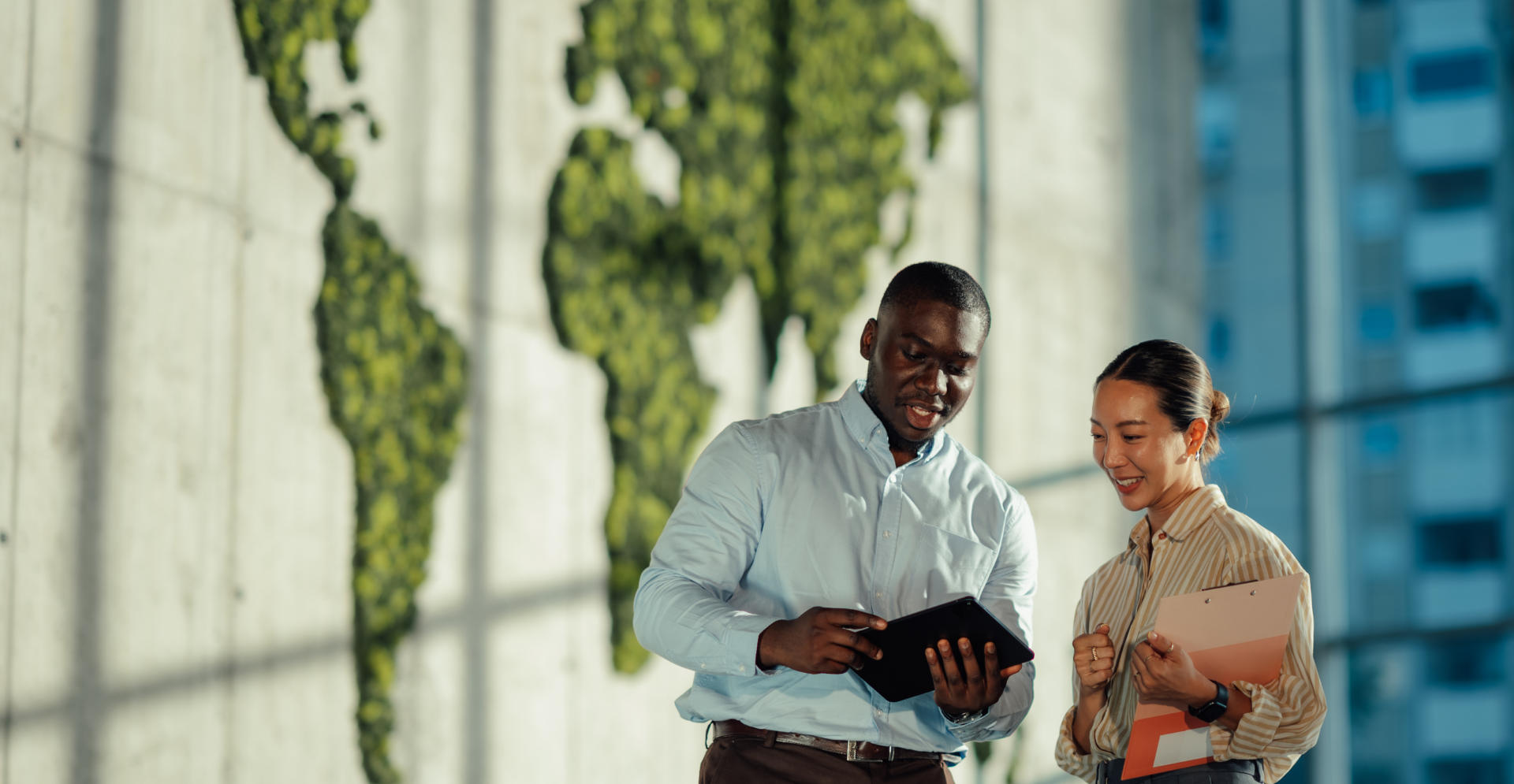 Twee zakenmensen staan voor een grote wereldkaart en bespreken wereldwijde strategieën en kansen.