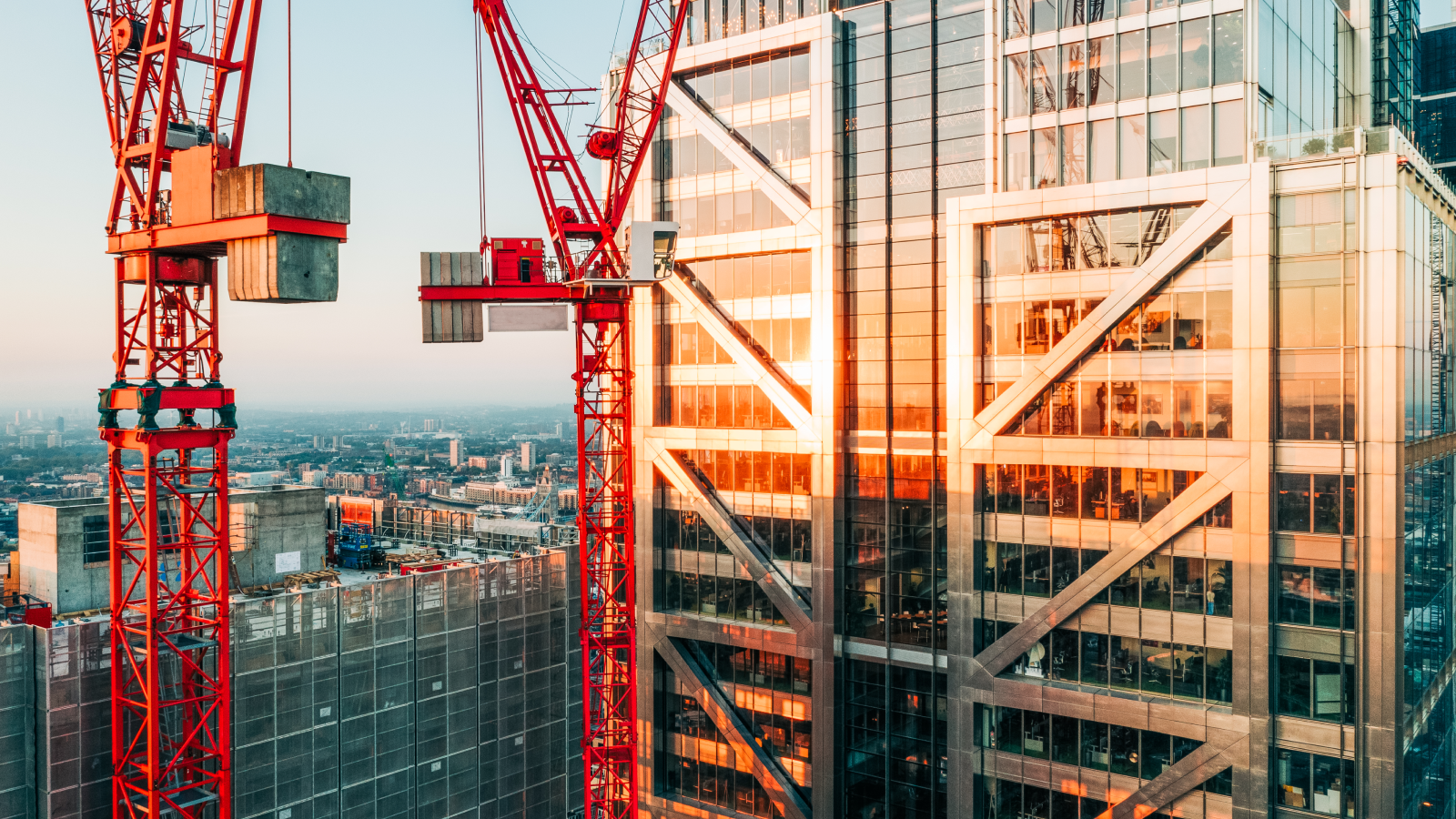 A crane located next to a building, illustrating the progress of construction in a cityscape.