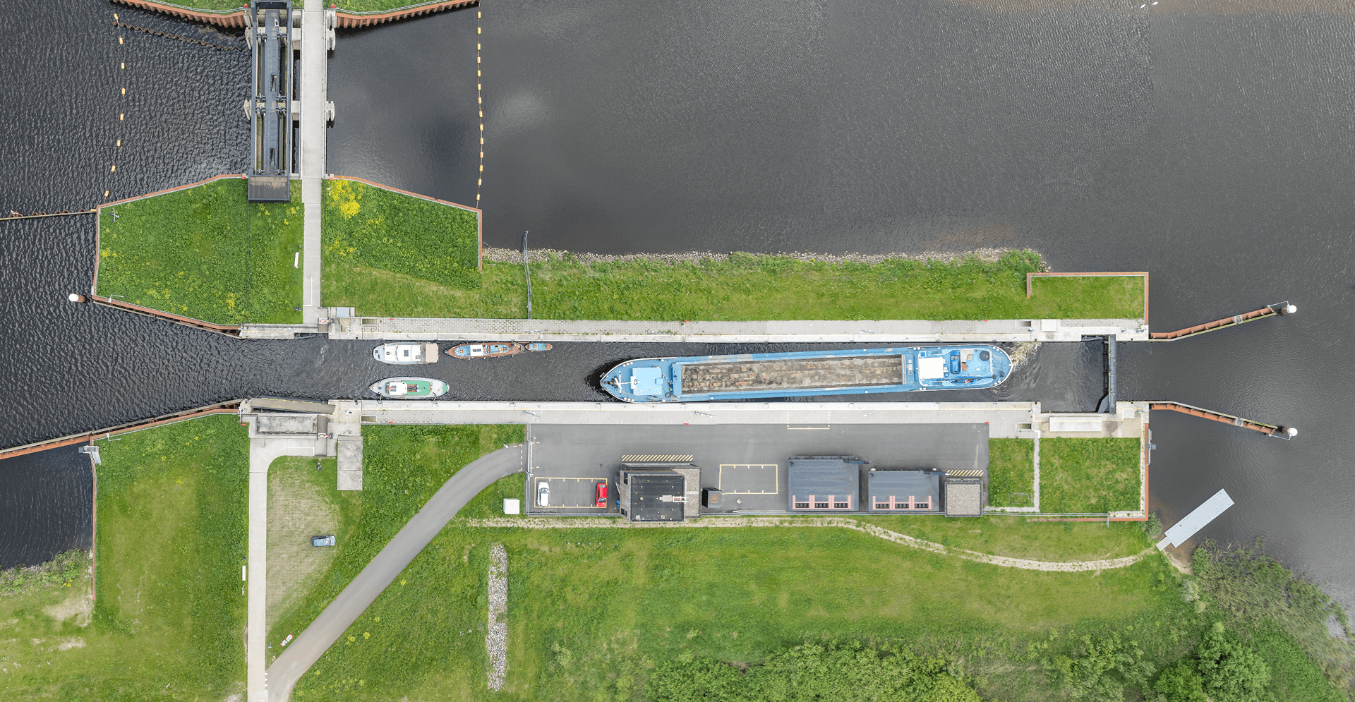 A boat navigates through a lock, surrounded by water and concrete walls, adjusting to the changing water levels.