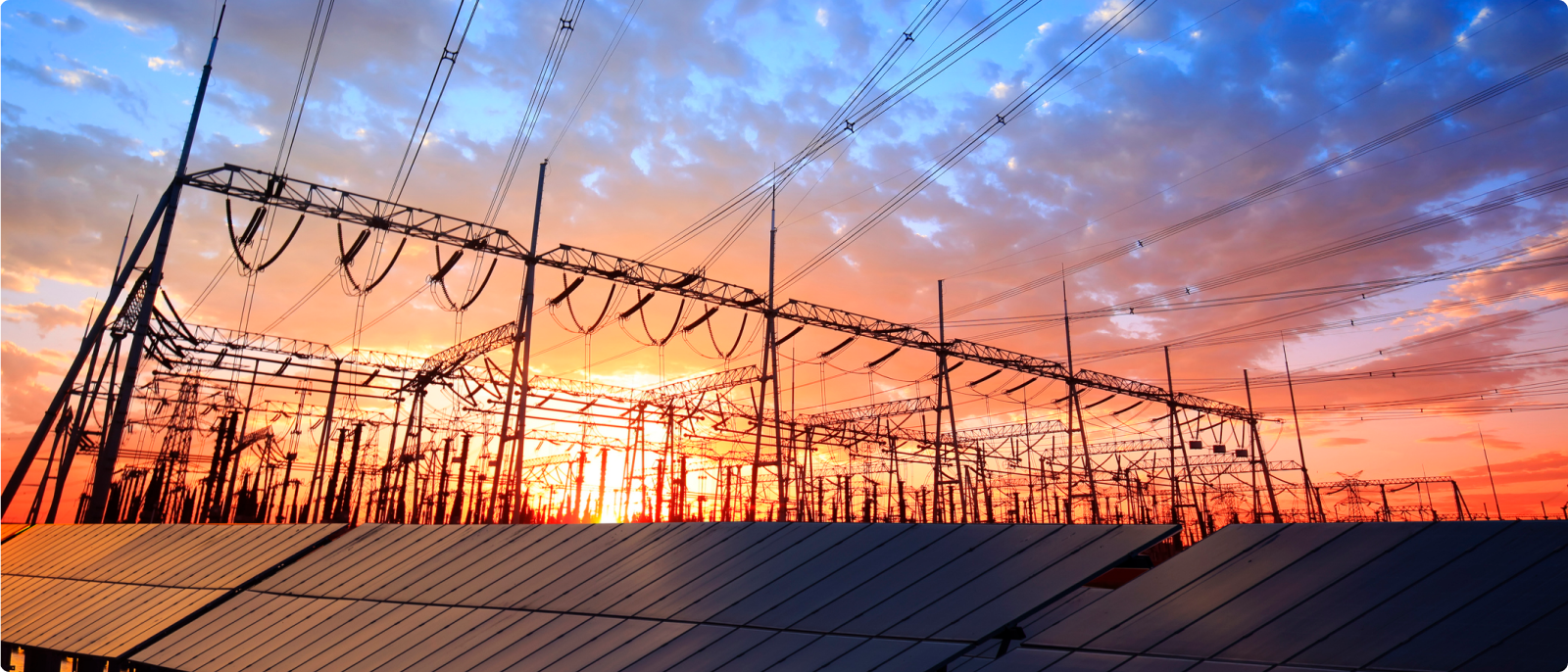 Electricity towers and power lines stand tall against a stunning sunset backdrop, illustrating the harmony of energy and the environment.