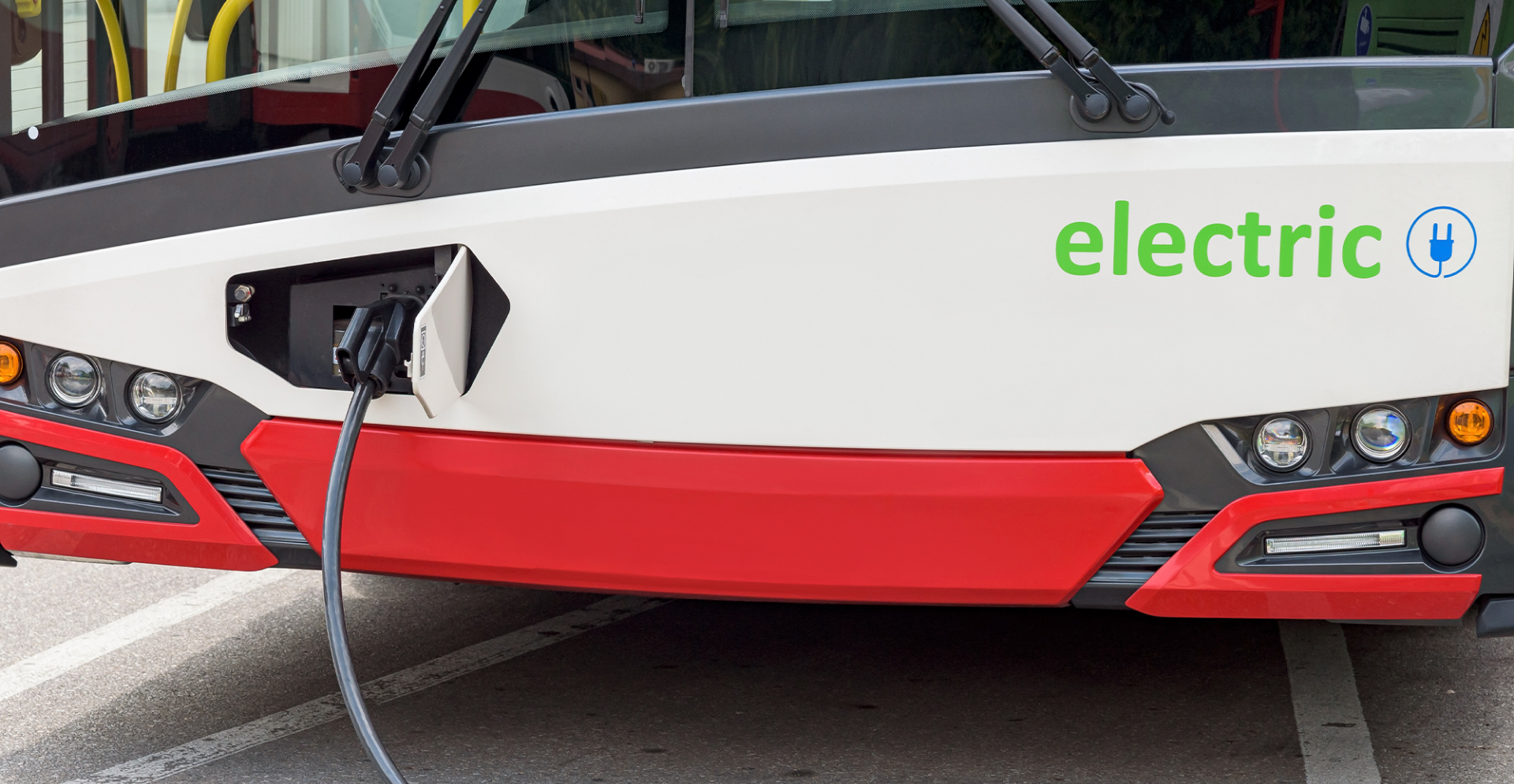 Electric bus charging at station.