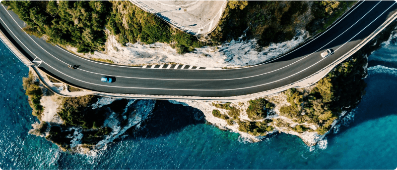 Aerial view of a winding road perched on the edge of a cliff