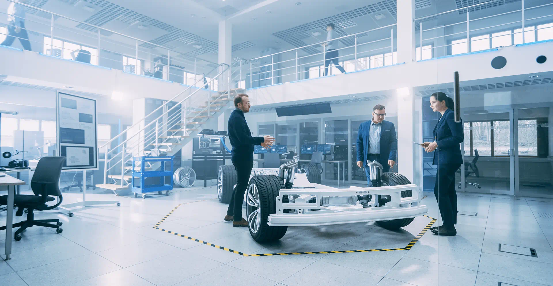 Two business-suited men pose in front of a luxury car, showcasing a blend of elegance and corporate demeanor.