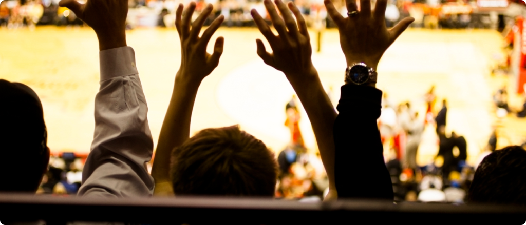 Large crowd people attend a sports event. Stadium. Basketball court.