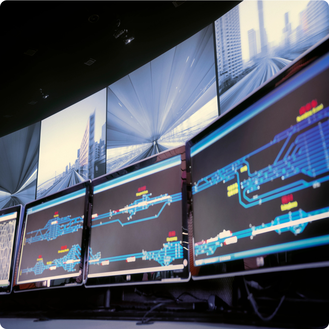A workstation with several computer monitors, each presenting various images, illustrating a multi-tasking environment.