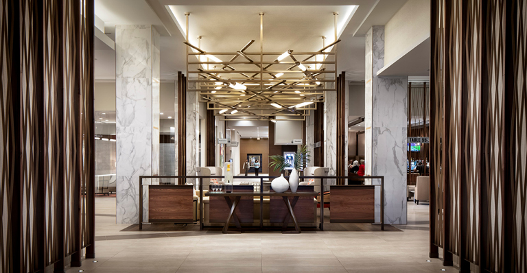 A luxurious hotel lobby featuring elegant marble floors and rich wood paneling, creating a sophisticated atmosphere.