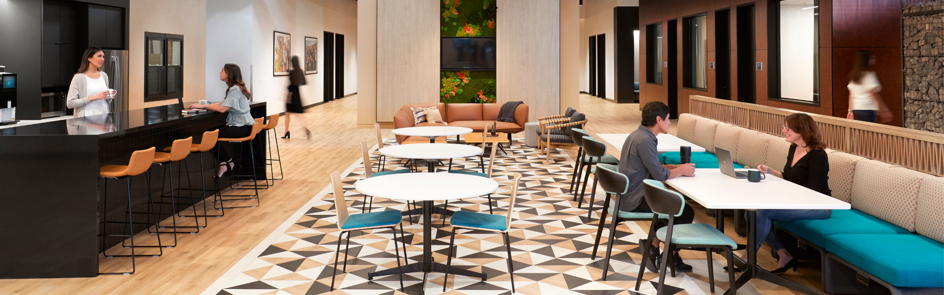 Spacious office lobby with large table and chairs.