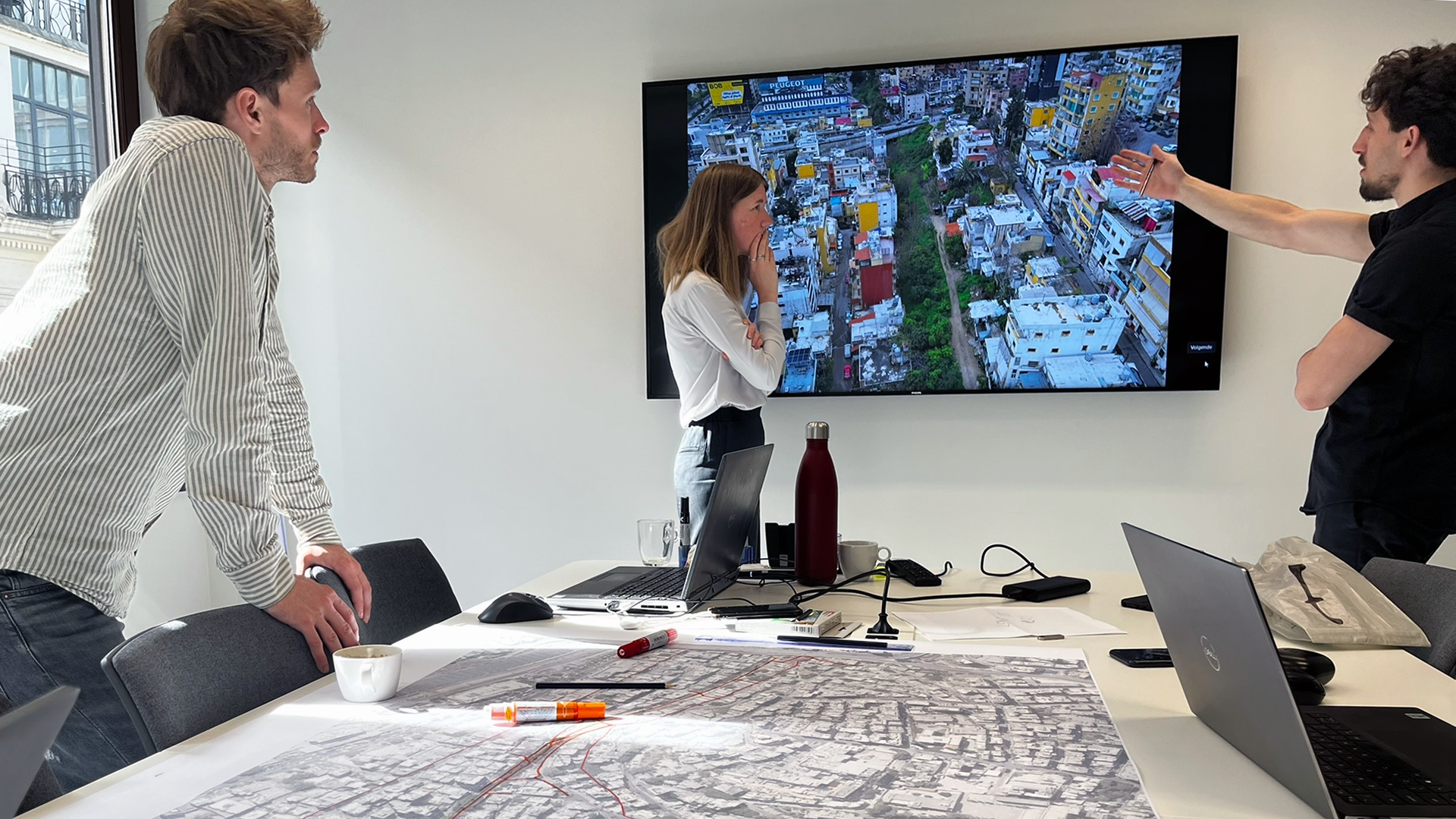  A group of diverse office workers collaboratively examining a large map on a table.