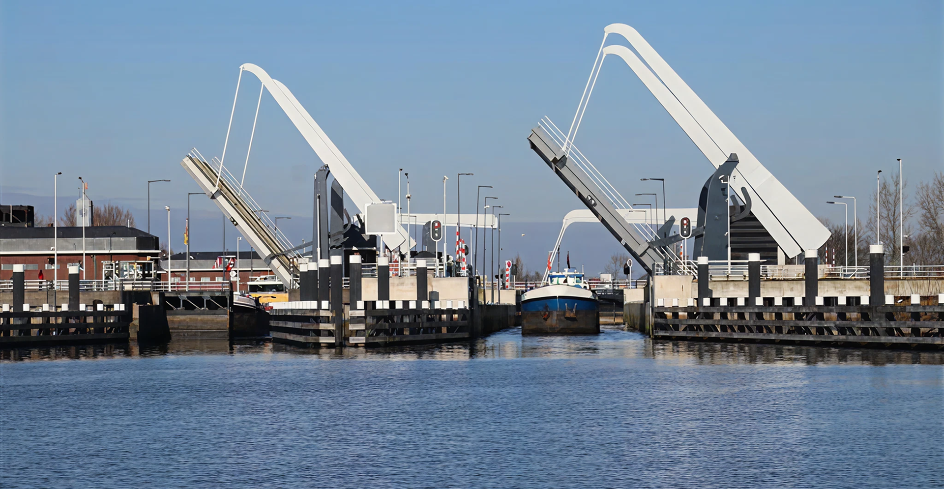 A large white bridge spans across a river