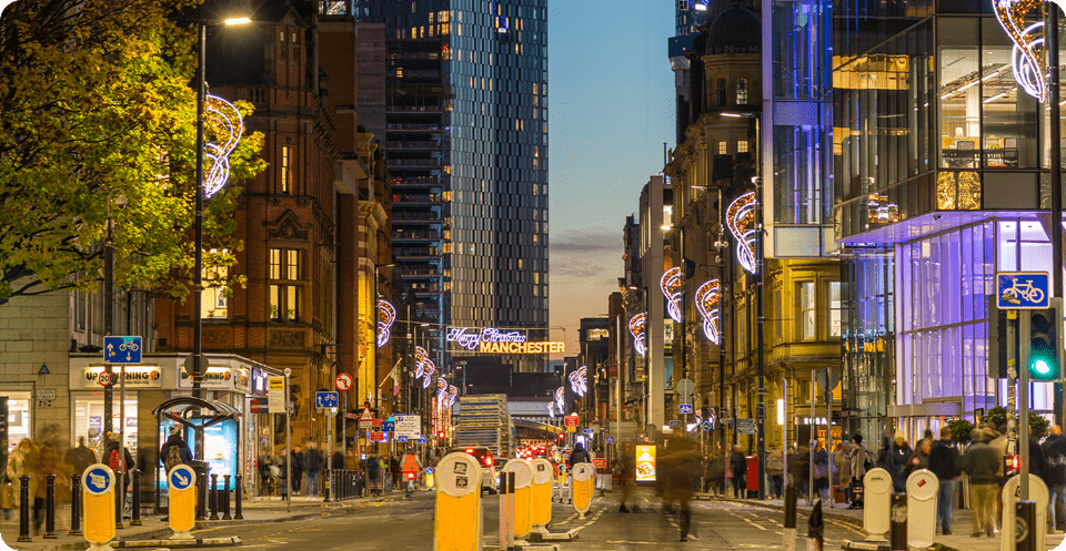 A lively urban street crowded with vehicles and pedestrians, showcasing the energy of city life.