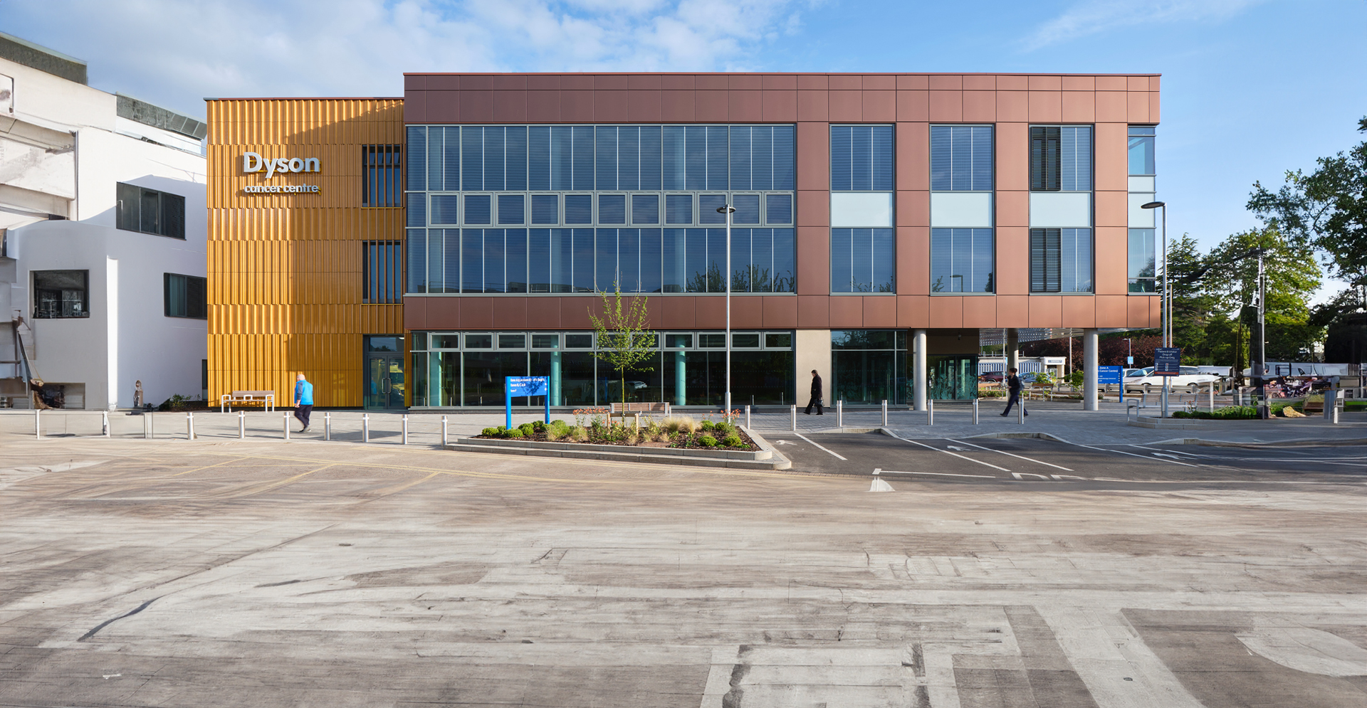 Exterior of building with large orange and brown facade, showcasing modern architecture.