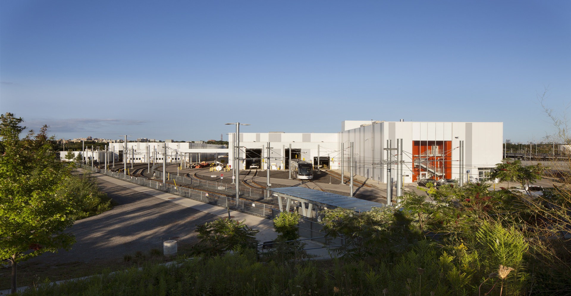 A large white building stands prominently next to a spacious parking lot.