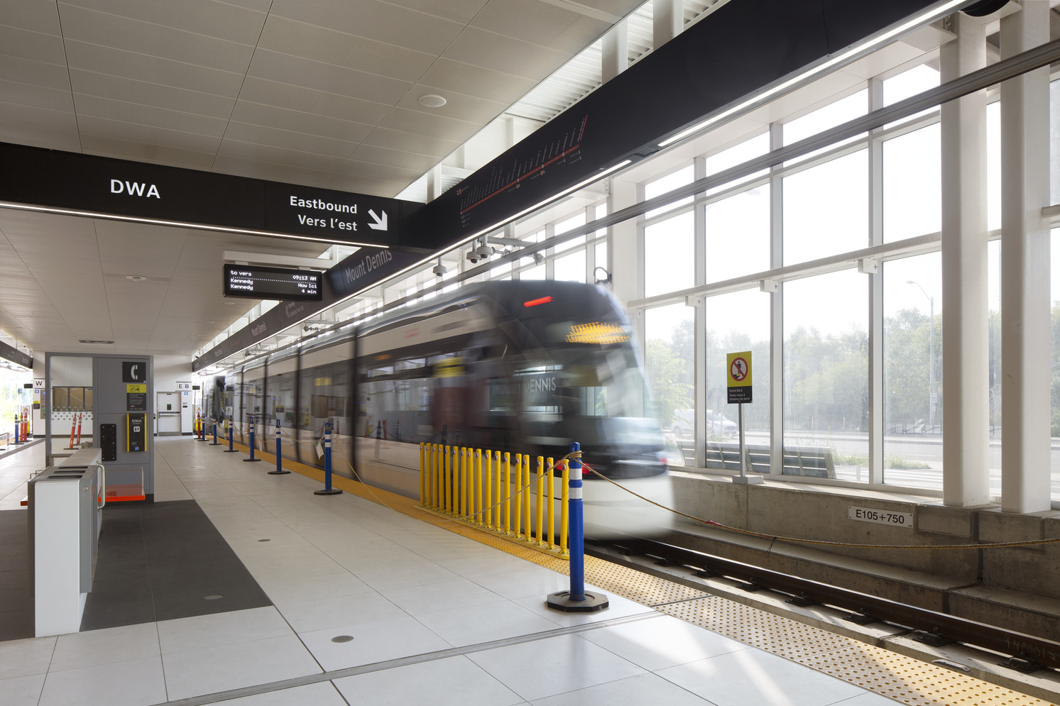 A train approaches the station, ready to stop and allow passengers to board and disembark.