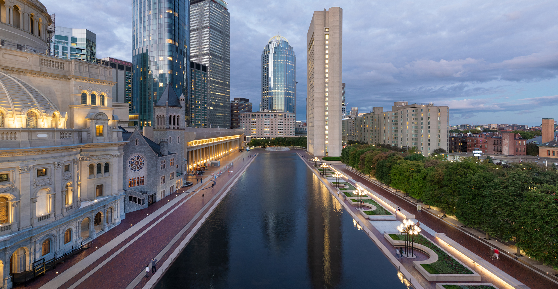 A vast expanse of water reflecting the sky, surrounded by distant landforms and a serene atmosphere.