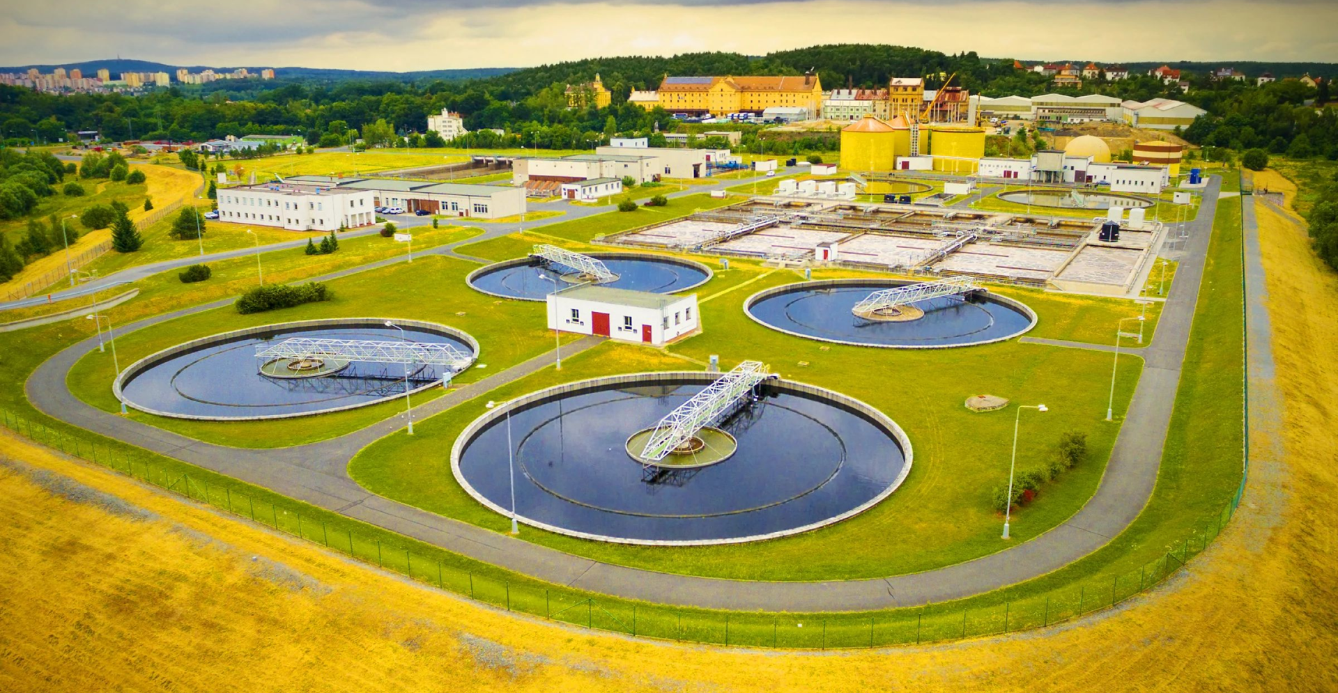 A sprawling water treatment plant with numerous tanks for processing water.